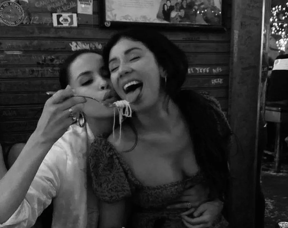 Two women close together in black and white