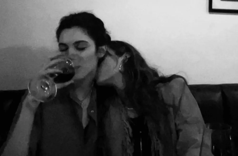 Two women about to kiss in black and white
